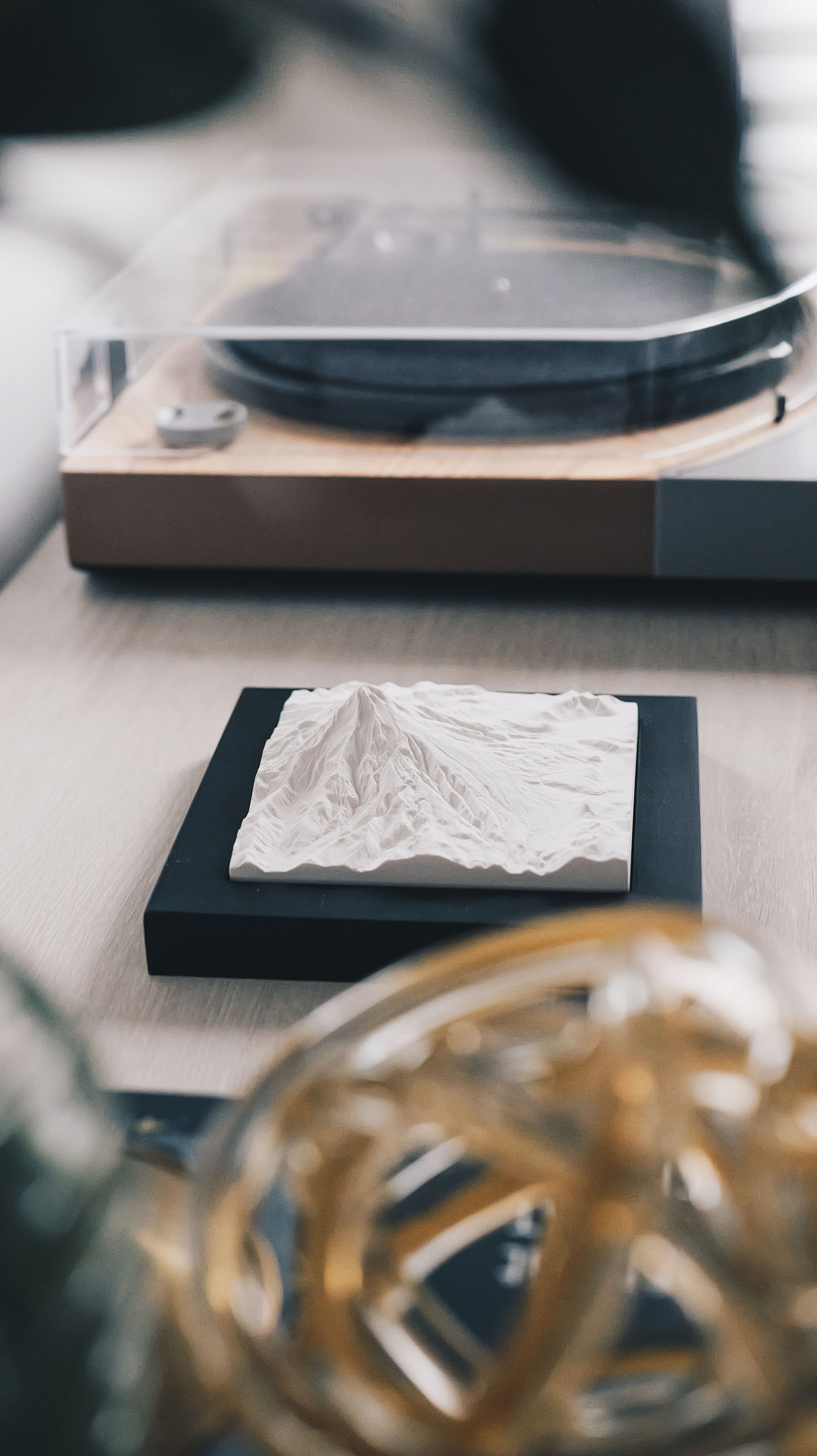 A mountain model sitting on a counter. 