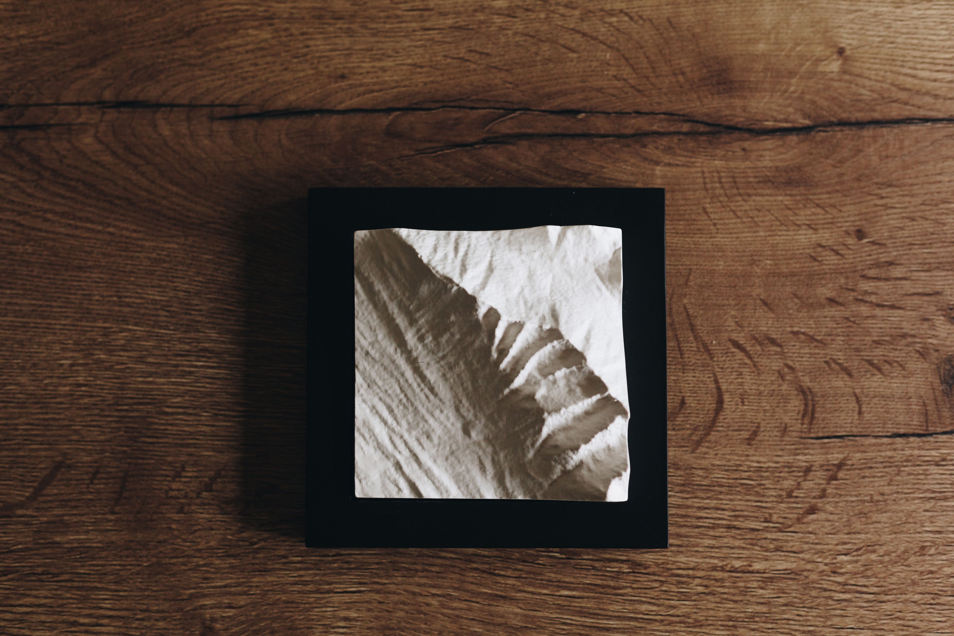 A mountain model sitting on a counter. 