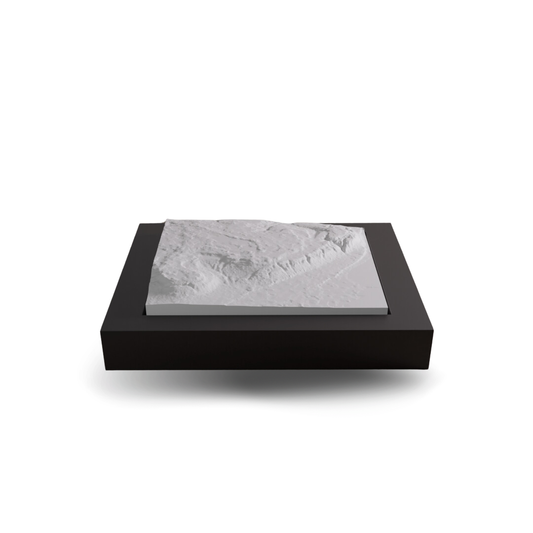 Black rectangular box with a gray marble-patterned lid on a white background