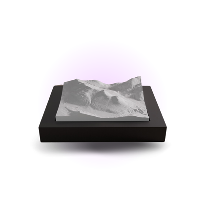 Mountainous landscape model on a black base with a white background