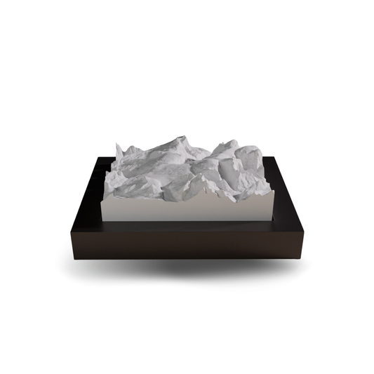 Decorative mountain sculpture on a black base with white mountain design