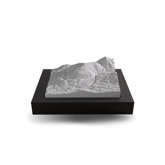 3D mountain model on a black base with a white background