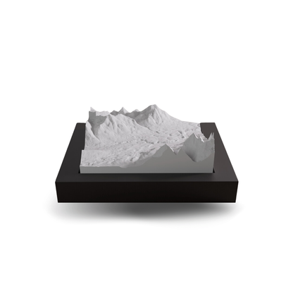 Model of a mountain landscape on a black base with a white background