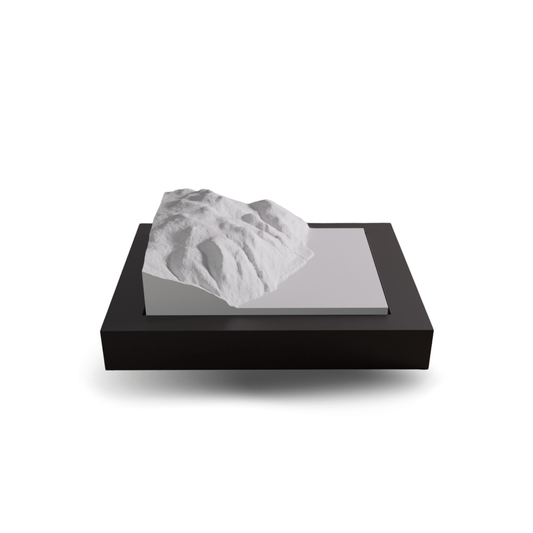 3D-printed mountain model on a black base with a white background
