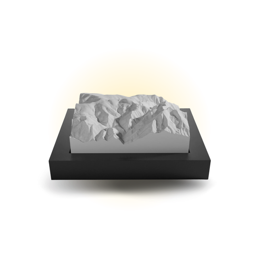 Mountainous landscape model on a black base with a white background