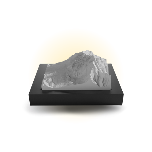 Mountainous sculpture on a black base with a white background