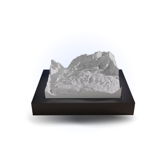 White stone sculpture on a black base against a white background