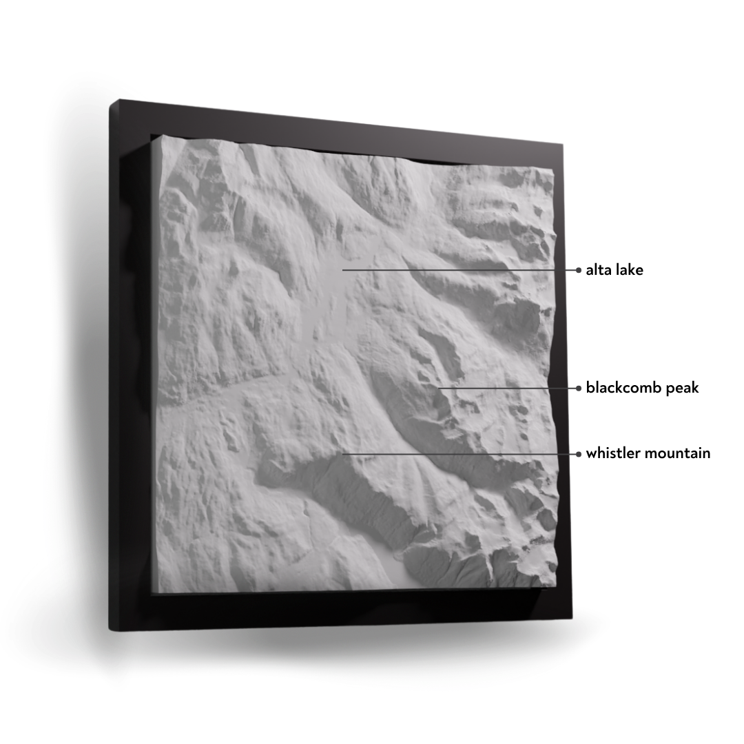 Framed black and white aerial photograph of a mountain landscape with labeled features.
