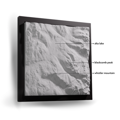 Framed black and white aerial photograph of a mountain landscape with labeled features.