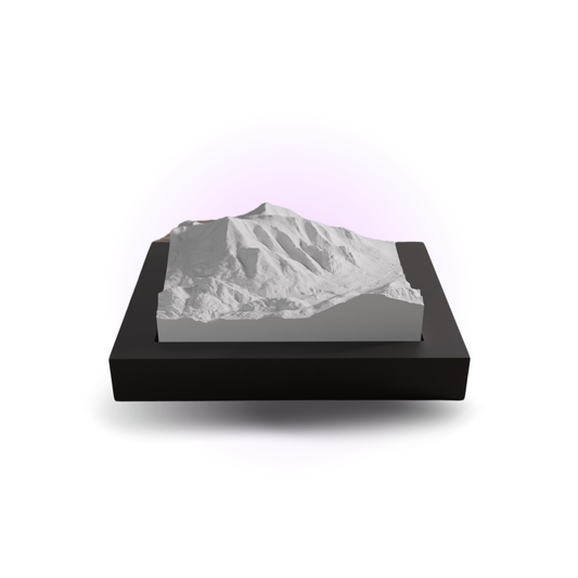 Model of a mountain on a black base with a white background