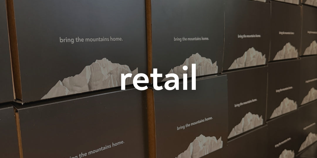 Stack of boxes with mountain graphic and 'retail' text